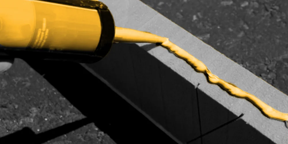 Hybrid sealant bead being run into a construction joint