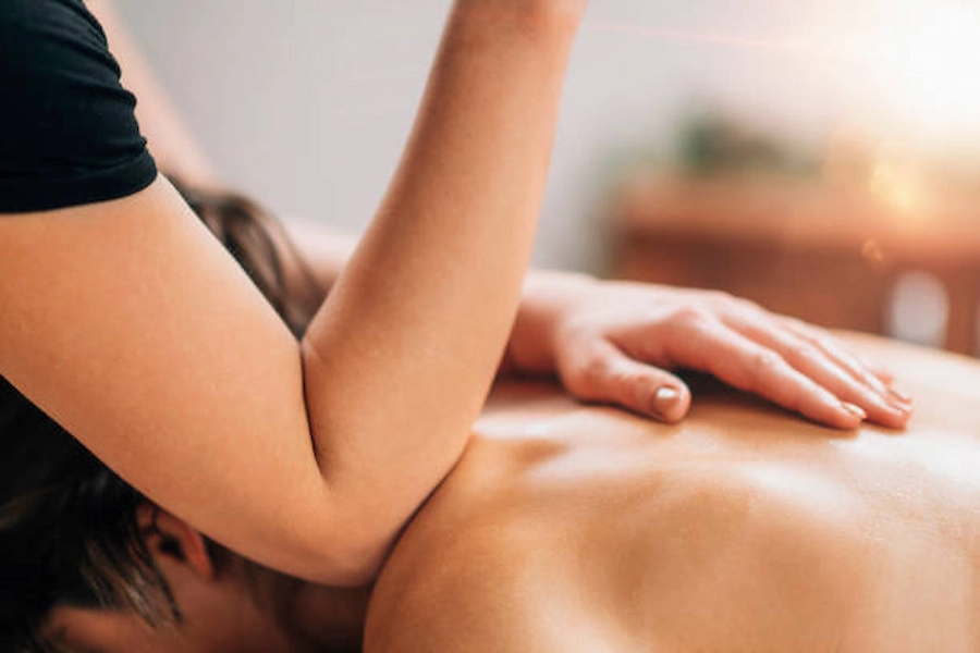 Therapist providing soothing shoulder massage treatment.