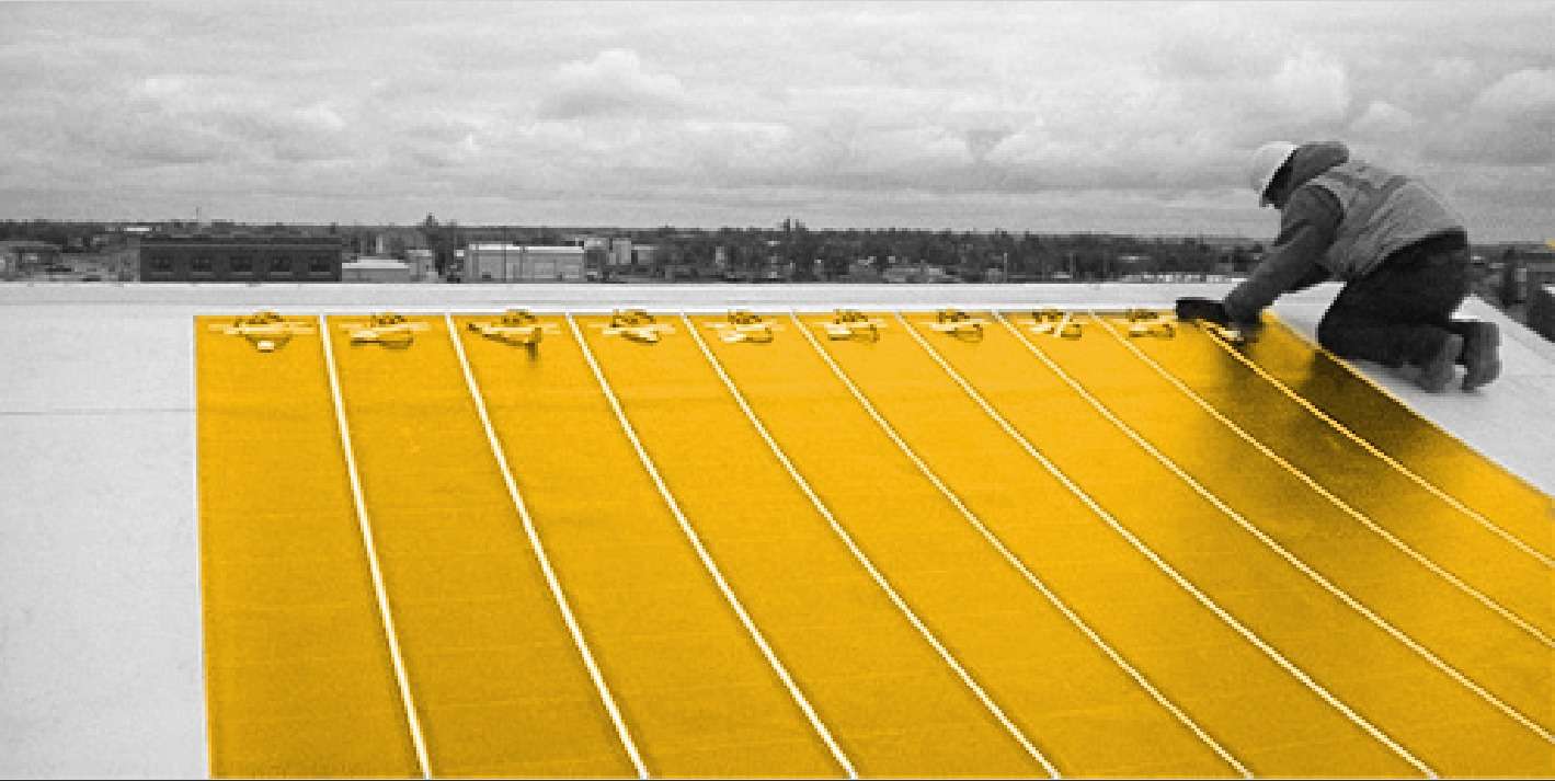 Insulation boards and lining laid out in strips across a roof deck