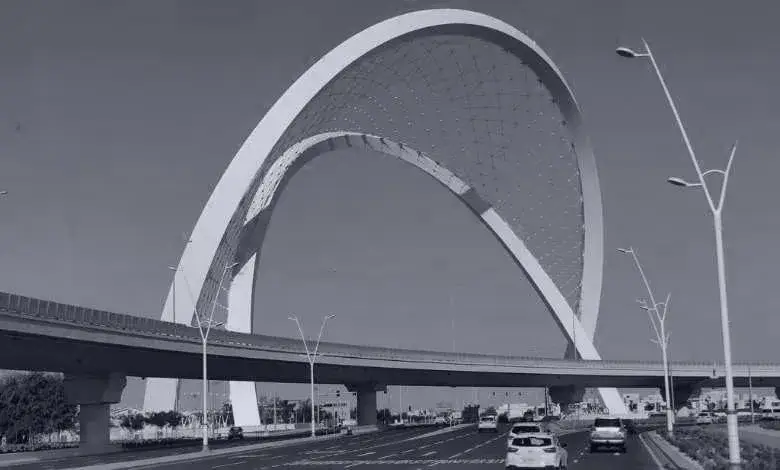 Arched highway bridge over a city road