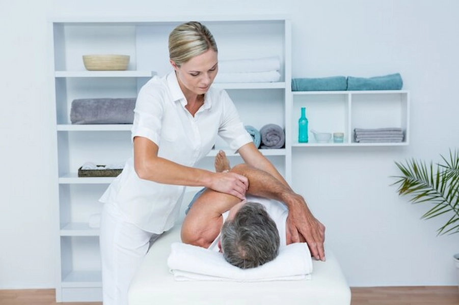 Client receiving therapeutic massage at ATOS Medical Center
