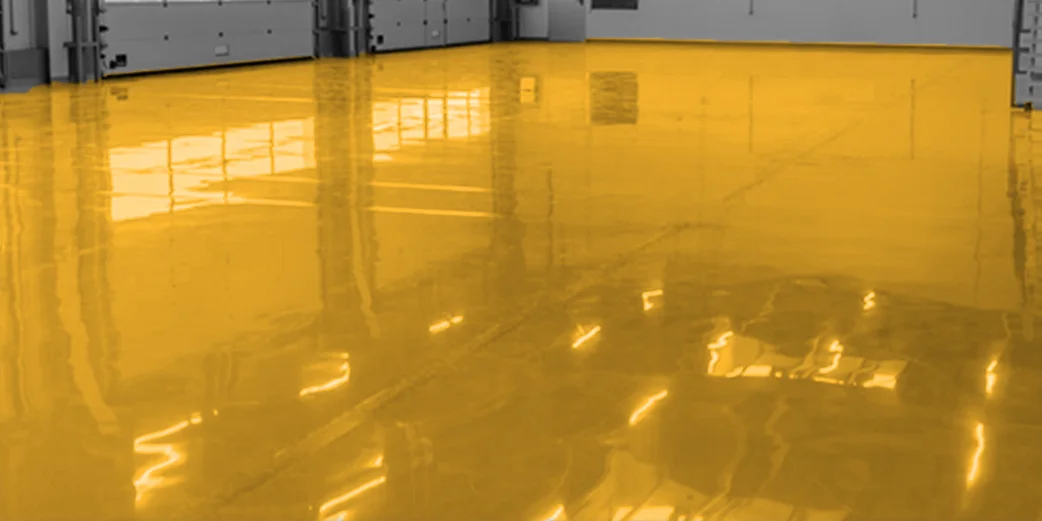 A poured epoxy floor running the length of an industrial hall