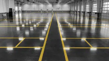 Line-marked epoxy floor running the length of a warehouse