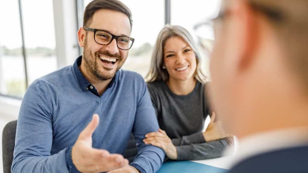 A couple in conversation with a property advisor