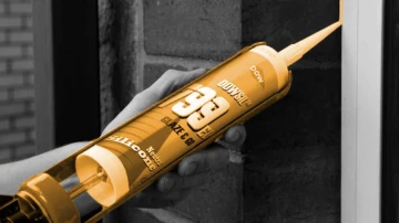 Applying a bead of Dowsil sealant along a wall joint