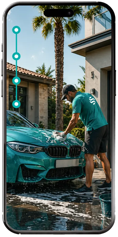 Detailer washing a car on a driveway