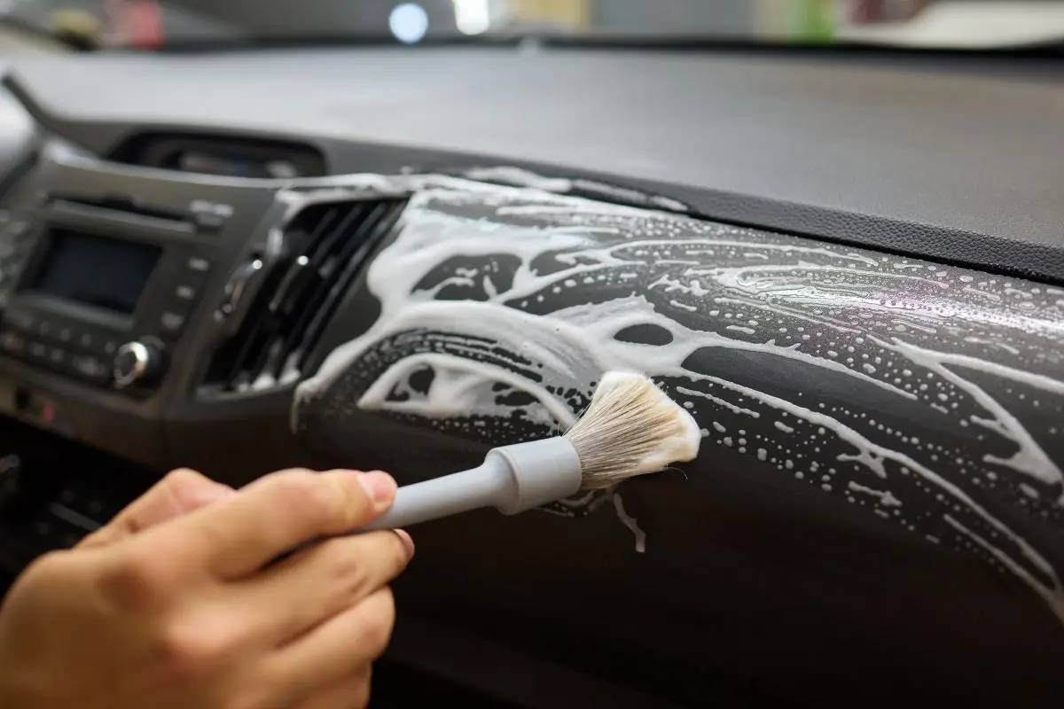 Detailing brush cleaning a foamed car dashboard