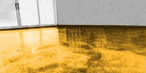 A mottled acid-stained concrete floor polished to a sheen