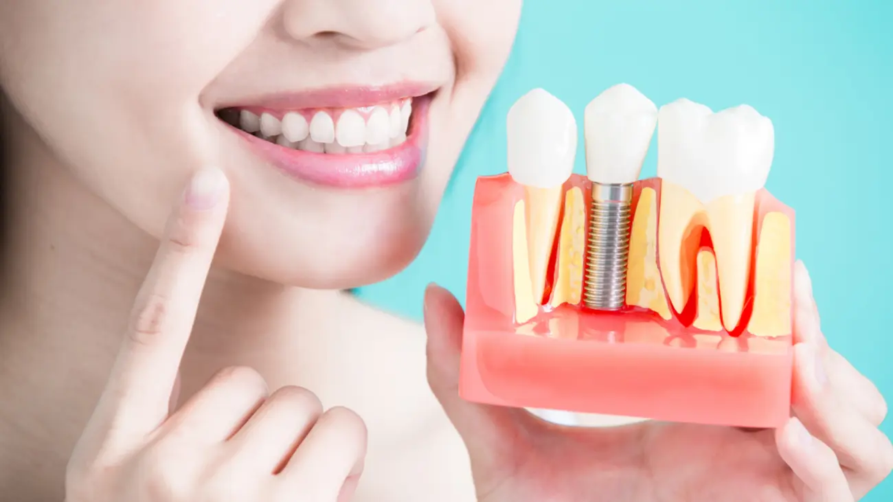 Patient smiling after dental implant success